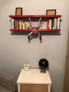 a clock mounted to the side of a wall next to a desk