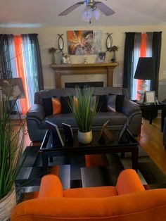 a living room filled with furniture and a fire place in the middle of the room