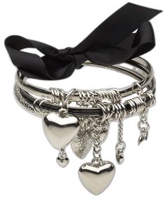 four different bracelets with hearts and charms on each one, including a black ribbon