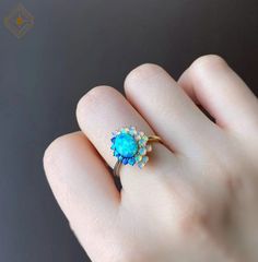 "Natural multi gemstone opal ring, oval shape natural Australian center opal stone surrounded by color shifting round crystal opals. Let your eyes get lost staring into the deep blue beauty of this ring, truly stunning and unique piece. In our original design, the ring band is in two colors which stands for ice and fire. But you will have the option to decide if you would like to have only one color for the band. 💎 Metal: 14k gold/14k white gold/14k rose gold, 18k gold/18k white gold/18k rose g Ethiopian Opal Oval Ring For Wedding, Exquisite Opal Ring For Gift, Exquisite Opal Ring Gift, Elegant Opal Cluster Ring With Gemstones, Ethiopian Opal Multi-stone Ring, Fine Jewelry Oval Multi-stone Opal Ring, Oval Multi-stone Opal Ring Fine Jewelry, Exquisite Multi-stone Oval Opal Ring, Opal Multi-stone Round Cut Rings