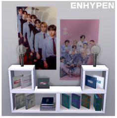 a shelf with books and pictures on it in front of a wall that says enhypen