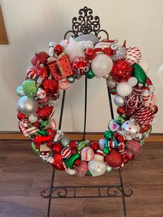 a christmas wreath with ornaments hanging from it