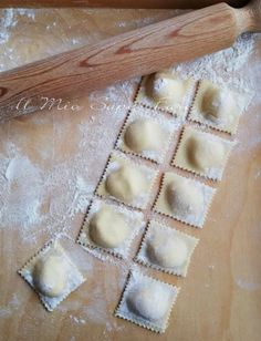 some ravioli and a rolling pin on a table