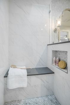 a bathroom with white marble walls and floor