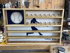 a baseball themed shelf in a garage with tools and other items on the shelves behind it