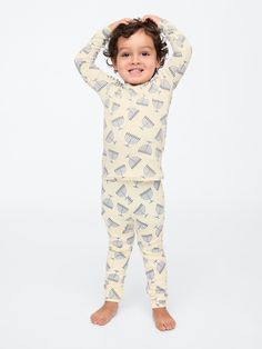 Soft cotton pajama top and pants set with a cozy brushed interior.  Crewneck.  Long sleeves.  Certain styles have embroidered Brannan Bear at chest.  Elasticized waist at PJ pants.  Assorted allover Holiday-themed prints.  Made with 100% organically grown cotton, which is grown without the use of synthetic pesticides and fertilizers.  This product was made in a factory that runs the Gap Inc.  P. A. C. E.  Personal Advancement & Career Enhancement) program.  P. A. C. E.  is our educational program that helps the women who make our clothes build the skills, knowledge, confidence & resilience needed to advance in work & life.  Learn more here.  Straight, easy fit.  Easy pull-on waist.  Sizes range from baby to toddler. Top And Pants Set, Support People, Gender Equality, Pj Pants, Cotton Pyjamas, Pajama Top, Brushed Cotton, Pj Sets, Work Life