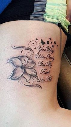 a woman's lower back tattoo with flowers and butterflies on her side, which reads you are the flower to my best friend