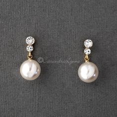 A larger pearl drop earring set of light ivory pearls that hang from two small round crystals. A classic looking wedding day earring style! They are silver or gold plated, titanium posts, 12mm synthetic pearls and 1 inch long. Hanging Pearl Earrings, Pearl Hanging Earrings Gold, Classic Pearl Drop Earrings For Wedding, Classic Pearl Chain Bridal Earrings For Anniversary, Classic Bridal Earrings With Pearl Chain For Anniversary, Classic Pearl Embellished Drop Earrings, Classic Pearl Earrings For Wedding, Classic Formal Bridal Earrings With Pearl Chain, Classic Pearl Drop Bridal Earrings