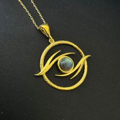 Labradorite Eye of Ra Necklace, 925 Sterling Silver Witchy Evil Eye Pendant, Labradorite Gothic Eye Amulet Necklace, Moonstone Eye Talisman 𓂀 Modern Minimalist Eye of Ra Necklace  𓂀 The Eye of Horus, an ancient Egyptian symbol, embodies protection, royal power, and good health.  Its mystic allure lies in its role as a potent amulet, transcending millennia to evoke a timeless emblem of divine safeguarding and prosperity. Item Details, ✔️ Made of certified 925 sterling silver ✔️ 14k Gold Plated Spiritual Hand Forged Labradorite Jewelry, Symbolic Hand Forged Necklaces, Hand Forged Moonstone Necklace With Round Pendant, Handmade Moon Amulet Jewelry, Handmade Moon-shaped Amulet Jewelry, Handmade Moon Shaped Amulet Jewelry, Mystical Round Cabochon Jewelry, Spiritual Labradorite Gemstone Necklace, Symbolic Moonstone Jewelry As A Gift