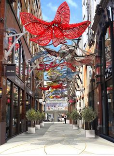 a street with lots of red decorations hanging from it's sides