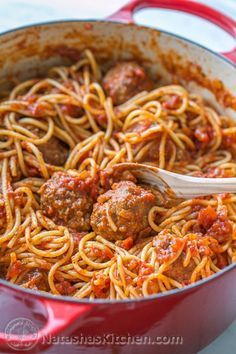 spaghetti with meatballs and tomato sauce in a red pot