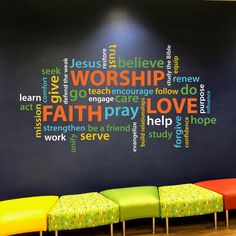 a colorful bench in front of a black wall with words written all over the place