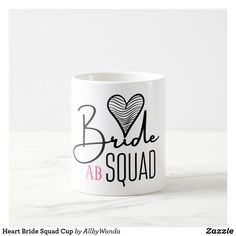 a white coffee mug with the words bride ab tribe printed on it and a heart