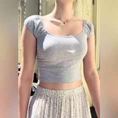 Short Sleeve, Fitted, Crop Top With An Elastic Scoop Neck And Sleeves. Fabrics: 96% Cotton, 4% Elastane Measurements: 12" (30 Cm) Length, 12.5" (32 Cm) Bust Made In: Europe Gray Stretch Tops For Summer, Trendy Fitted Gray Tank Top, Trendy Gray Summer Tops, Chic Fitted Gray Crop Top, Summer Gray Cotton Crop Top, Trendy Cropped Gray Tops, Trendy Gray Cropped Tops, Trendy Fitted Gray Crop Top, Fitted Gray Crop Top