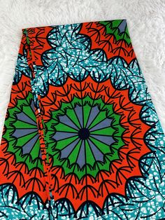 This Orange and teal African Fabric is high quality African print made from 100% cotton and it's 45 inches wide. It is used for making African Clothing, African quilts, & For Home decoration. FYI: Print is Double sided. The listing is for 1, 6 yards and Headwrap Each piece of fabric measures:  36in by 45in for 1 yard 216in by 45in for 6 yards 70in by 22in for Head wrap If you purchase more than one yard, you will receive one continuous piece. *If you require more than what I have listed, feel free to send me email. CARE INSTRUCTIONS: *DO NOT BLEACH *Hand wash with cold water and mild soap or Dry clean *Press with hot iron for a crispy look. Color may be different due to your monitor Traditional Green Printed Fabric, Green Traditional Fabric With Colorful Pattern, Traditional Green Fabric With Colorful Pattern, Colorful Green Ankara Fabric, Green Ankara Fabric With Colorful Pattern, Ankara Fabric With Vibrant Patterned Print, Vibrant Patterned Ankara Fabric, Green Printed Ankara Fabric, Green Bohemian Cotton Patterns