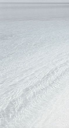 a man riding skis down a snow covered slope