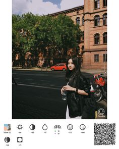 a woman standing in front of a tall building next to a street with cars on it