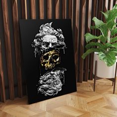 a black and white poster with two skulls on it next to a potted plant