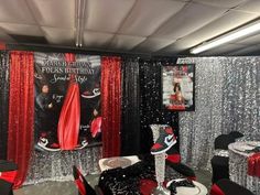 a party room with red and black decorations, silver sequins and streamers