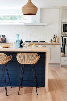 two wicker stools sit at the kitchen island