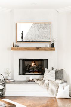 a living room with a fire place and white walls