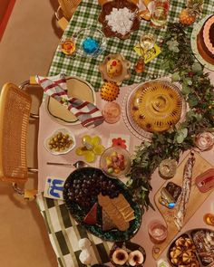 a table filled with lots of food on top of a checkered table cloth