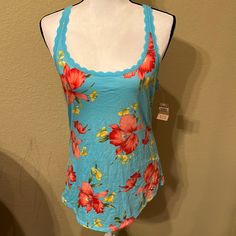 Nwt Hollister Brand Women’s T-Back Tank Top; Betty’s Large Style; No Holes Or Stains; 100% Cotton; Non-Smoking Home Casual Blue Floral Print Sleepwear, Blue Cotton Racerback Top, Trendy Blue Racerback Top, Casual Floral Print Tank Top, Pink Racerback Top For Loungewear, Stretch Scoop Neck Vacation Tops, Stretch Scoop Neck Top For Vacation, Casual Spring Tank Sleepwear, Spring Loungewear Racerback Top