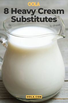 a glass pitcher filled with milk sitting on top of a wooden table next to the words, 8 heavy cream substitutes