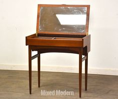 a wooden desk with a mirror on top