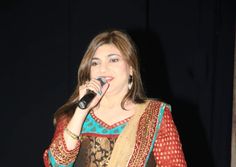 a woman standing in front of a microphone