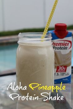 a glass jar filled with liquid next to a carton of protein milk on top of a table