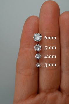 These classic, minimalist round cubic zirconia stud earrings are made of .925 sterling silver. They come with a push back and a 10mm post. Choose from a single stud earring, or a pair. Available Sizes (see photos for size reference): - 3mm - 4mm - 5mm - 6mm Looking for more earrings? Check out our collection: https://charmphilosophy.etsy.com ♥ PACKAGING ♥ Our earrings come in a jewelry box with a jewelry card background. If you would like a custom message included on the jewelry card background, Classic Round Cut Cubic Zirconia Piercings, Classic Round Piercings With Prong Setting, Minimalist Cubic Zirconia Anniversary Piercings, Minimalist Cubic Zirconia Piercings For Anniversary, Classic Diamond White Cubic Zirconia Piercings, White Gold Round Brilliant Cut Piercings, White Gold Brilliant Cut Piercings, Classic White Round Piercings, Minimalist Cubic Zirconia Piercings With Prong Setting