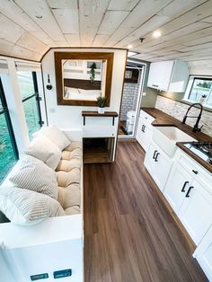 the interior of a tiny home with wood flooring