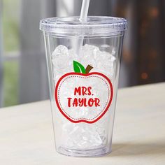 a plastic cup filled with ice and an apple