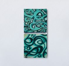 two pieces of art hanging on the wall in front of a white wall with blue and green designs