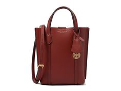 Tory Burch Mini Perry Tote - Tote Handbags : Bricklane : Carry your essentials in chic style effortlessly in the Tory Burch Mini Perry Tote. Top carry handles. Removable crossbody strap. Center zipper compartment. Two interior slip pockets. Removable double-T charm. Dust bag included. Shell: 100% leather, Lining: 50% nylon, 50% polyurethane. Imported. Elegant Medium Workwear Bags, Chic Medium Bag With Gold-tone Hardware, Elegant Tan Bucket Bag For Travel, Medium Bags With Gold-tone Hardware For Everyday Use, Medium Bags With Gold-tone Hardware, Chic Medium Satchel With Detachable Handle, Elegant Medium Bag With Top Carry Handle, Elegant Formal Bags, Elegant Medium Formal Bag