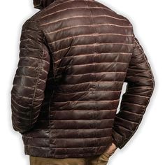 Rugged style meets winter warmth in our Men's Brown Leather Puffer Jacket. Crafted from supple, genuine leather with a rich brown hue, this jacket features quilted puffer insulation for superior heat retention. The classic silhouette is enhanced with a stand-up collar, zippered front, and snug cuffs to keep the cold at bay. Practical side pockets provide storage and hand-warming comfort. Perfect for the fashion-conscious man who doesn't compromise on functionality, this jacket seamlessly transitions from outdoor adventures to city streets. Key features: Premium brown sheepskin leather exterior for durability and style Quilted puffer design for superior insulation Adjustable hem to seal out cold air Multiple pockets for convenient storage Satin lining for a luxurious feel Premium YKK zipper Biker Shirts Women, Spiked Leather Jacket, Mens Leather Blazer, Motorcycle Leather Vest, Racer Jackets, Biker Accessories, Flannel Vest, Varsity Jacket Women, Leather Puffer Jacket