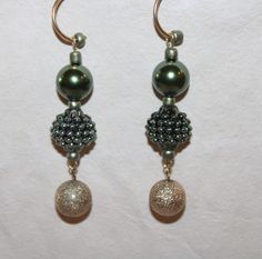 These light weight earrings are three round ball beads on a semi-hoop gold tone pierced earring.  The top bead is a satin finish rich color green and the middle green bead is a vintage bumpy yet satin finish green bead and the bottom bead is a vintage gold tone textured bead.  They weigh in at an ounce each and are about 2 inches long from the hoop. Green Drop Earrings With Gold Beads, Green Gold Beaded Drop Earrings, Elegant Green Beaded Earrings With Gold Beads, Elegant Green Beaded Hoop Earrings, Green Dangle Earrings With Spacer Beads, Elegant Green Earrings With Gold Beads, Light Weight Earrings, Green Bead, Earings Piercings