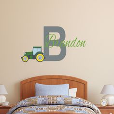 a bed room with a neatly made bed and a wall decal