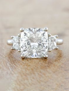 caption:Shown with 4ct center diamond in platinum Cushion Moissanite Engagement Ring, Diana Ring, Engagement Ring For Him, Cushion Cut Diamond Ring, 3 Stone Engagement Rings, Cushion Cut Diamond, Lab Diamond Engagement Ring, Dream Engagement Rings, Yellow Gold Setting