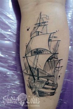 a black and white photo of a ship tattoo on the leg