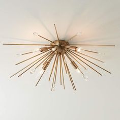 a chandelier hanging from the ceiling in a room with white walls and flooring