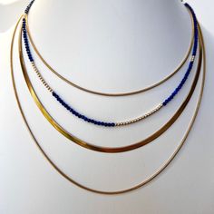 This faceted lapis lazuli and 14K gold bead strand necklace with a lobster clasp is delicate and perfect to add a touch of chic style. Wear alone for a classic look or layer it for your own unique fashion statement. Beaded necklace with faceted lapis lazuli gemstones 14K yellow gold beads + findings Lobster clasp closure shipping : allow up to a week from date your order was placed for shipping Gold Single Strand Lapis Lazuli Beaded Necklace, Elegant Gold Beaded Necklaces With Lapis Lazuli, Gold Lapis Lazuli Faceted Beads Necklace, Gold Lapis Lazuli Necklace With Faceted Beads, Gold Gemstone Necklace, Bead Strand, Strand Necklace, Gold Beads, Gemstone Necklace