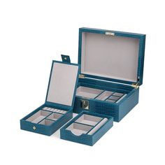 two blue leather jewelry boxes sitting next to each other