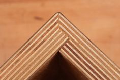 two pieces of wood are stacked on top of each other in the shape of a triangle