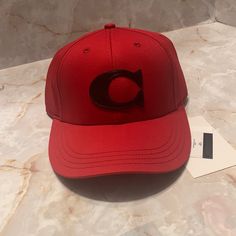 Coach Red Varsity Baseball Cap. This Cap Is Made Out Of Organic Cotton, Red In Color With Their Signature C In Black Leather On It . Size Medium/ Large. Classic Red Snapback Hat With Curved Brim, Classic Red Snapback Baseball Cap, Classic Red Hat With Embroidered Logo, Classic Red Snapback Cap, Red Sporty Trucker Hat With Curved Bill, Classic Red Snapback Hat For Sports, Sporty Red Trucker Hat With Curved Bill, Classic Red Fitted Hat For Sports, Red Sporty Visor Trucker Hat