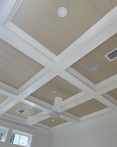 the ceiling in this room is made of wood and has white trimmings on it