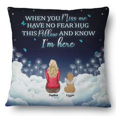 a pillow with an image of two people sitting in the clouds and one is holding a teddy