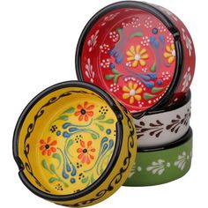 three colorful bowls are stacked on top of each other, one is painted with flowers