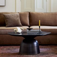 a living room with a couch, coffee table and candlestick